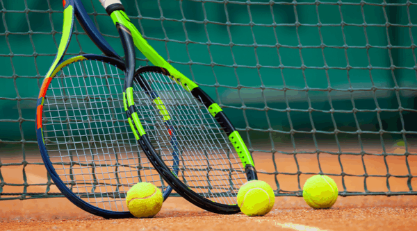 A picture of two tennis rackets and balls