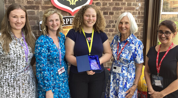 Winner Ella Hamilton is holding a trophy surrounded by Helen Bolt (Head of Sixth Form at JKHS), Emma Skelton (Acting Head of Sixth Form at JKHS), Ann Shawcross (Keith Shawcross' wife) and Arpinder Dhillon (Head of HCR's Wye Valley Office)