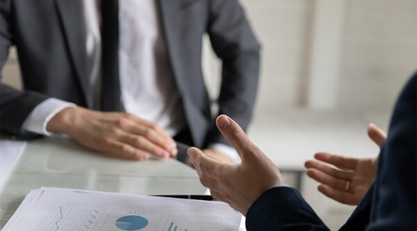 Two people in suits having a discussion