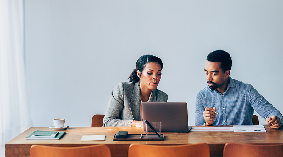 Two legal professionals discussing a tribunal case