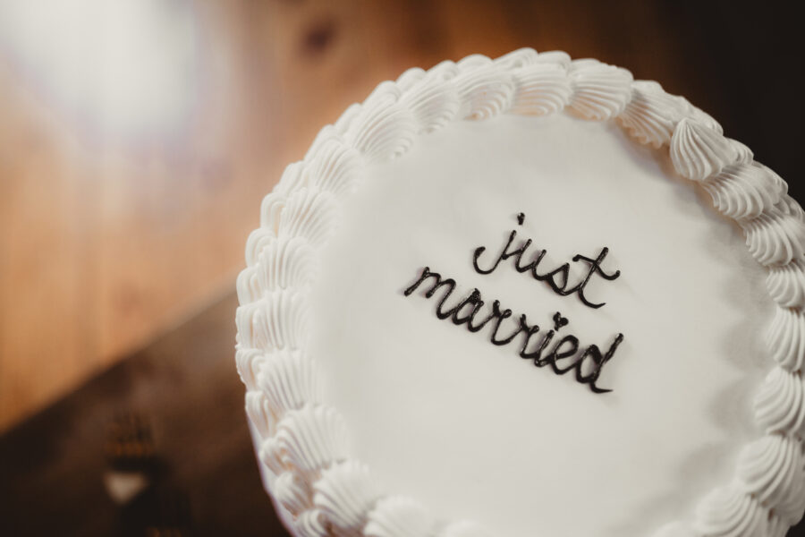 Vanilla wedding cake with 'just married' writing on top
