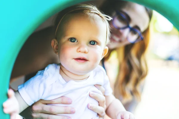 baby and mother playing in the playground
