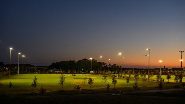 Junior teams training in illuminated soccer fields at a new community sport park