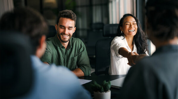 Group of friends sitting at a table and laughing