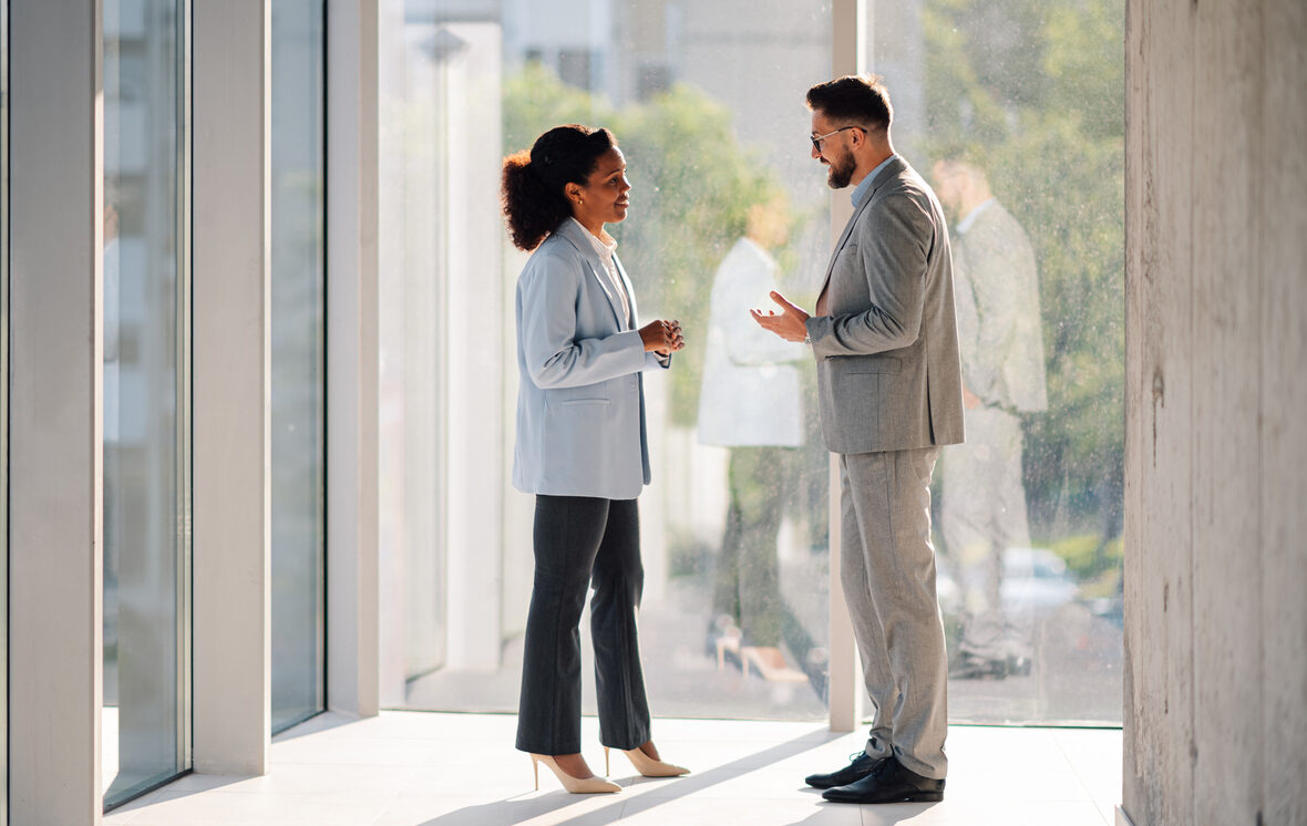 two people talking in a hallway