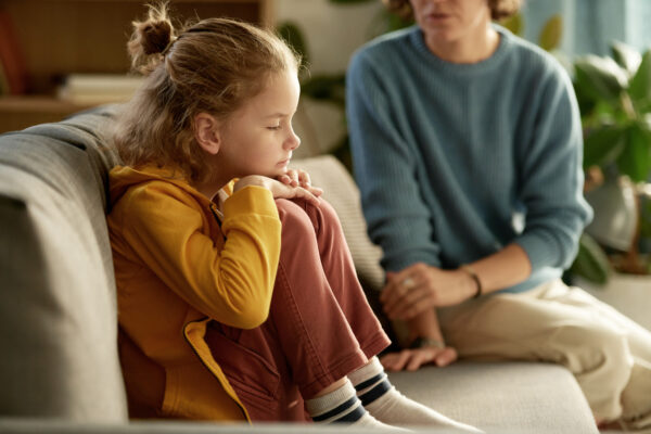 Children sitting on the sofa talking