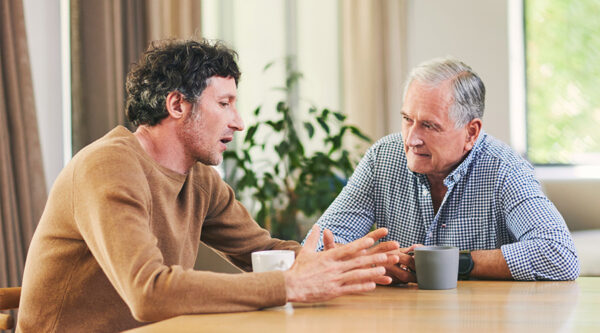 A father and son discussing succession