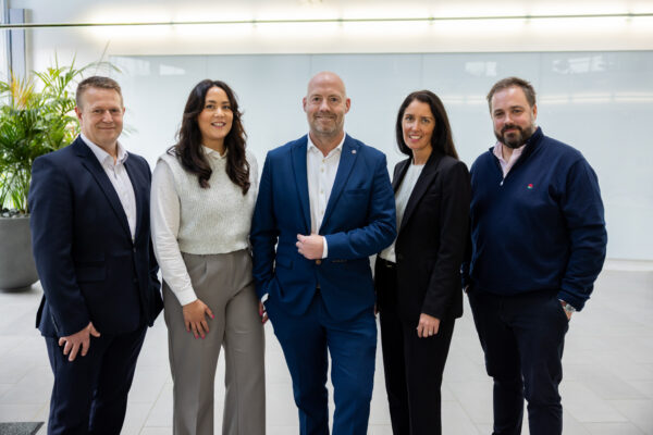Five Norwich Partners standing in a foyer