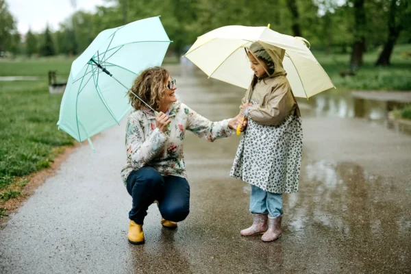 An adult and child in the rain