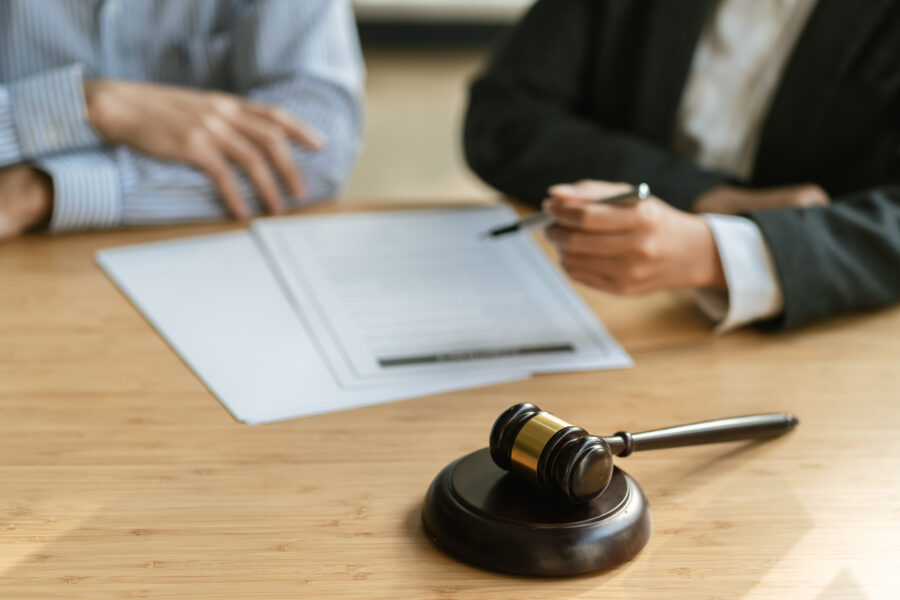 Legal counsel presents to the client a signed contract with gavel