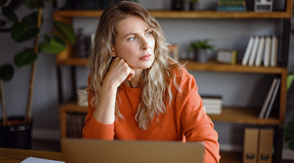 A lady resting her head on her hand