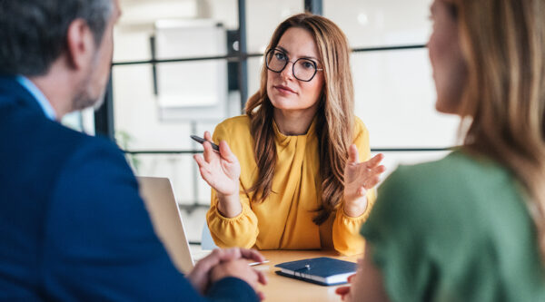 Three people discussing professional negligence