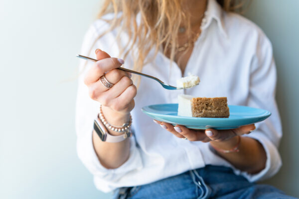 A woman eating a cheesecake