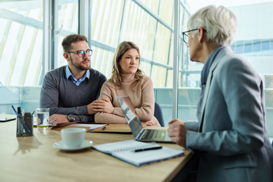 Young couple talking to their lawyer during a meeting in the office.