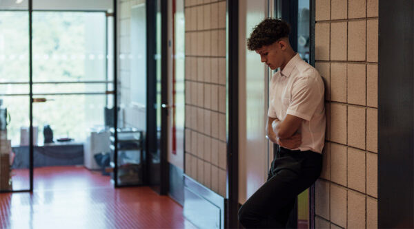 A pupil standing outside a teacher's office