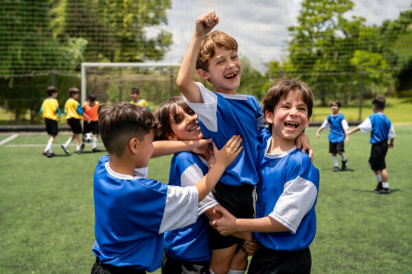 Some kids playing football at a sports club