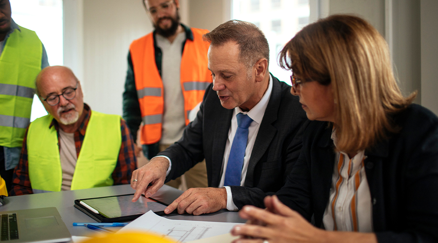 Builders and directors in a meeting room