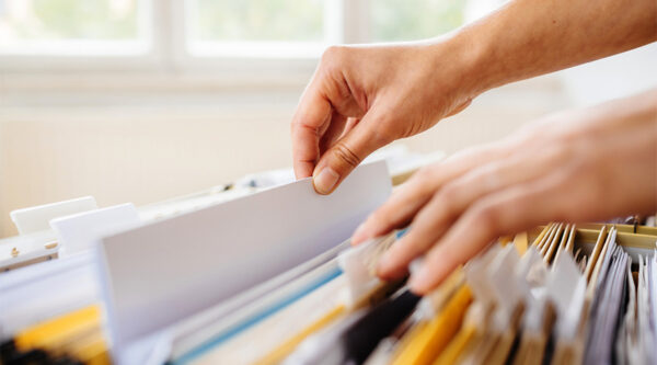 person looking in a file cabinet