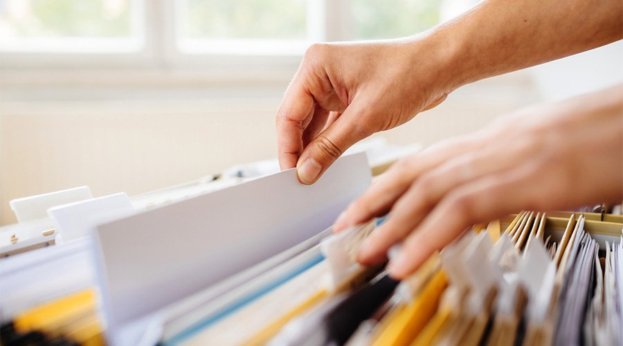 person looking in a file cabinet