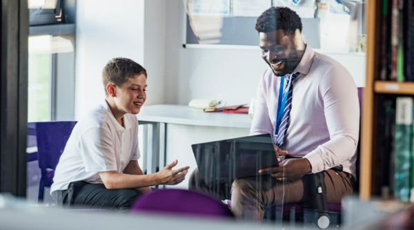 Pupil and teacher talking in a classroom