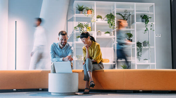 Couple at home looking at laptop in their living room