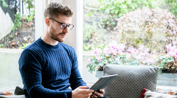 A man checking his service agreements on an ipad
