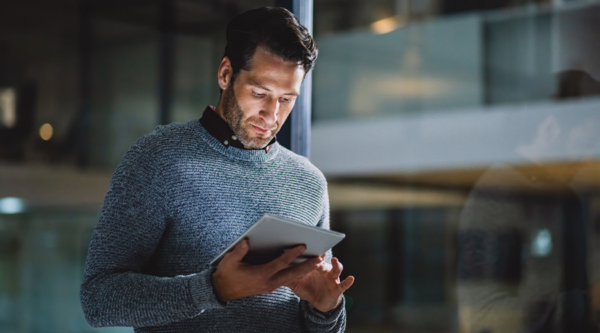 Men looking at his digital tablet