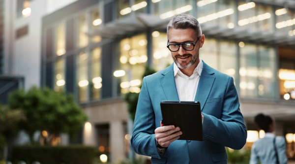 Lawyer with a digital tablet in front of a building