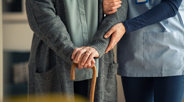 Carer holding elderly's person hand