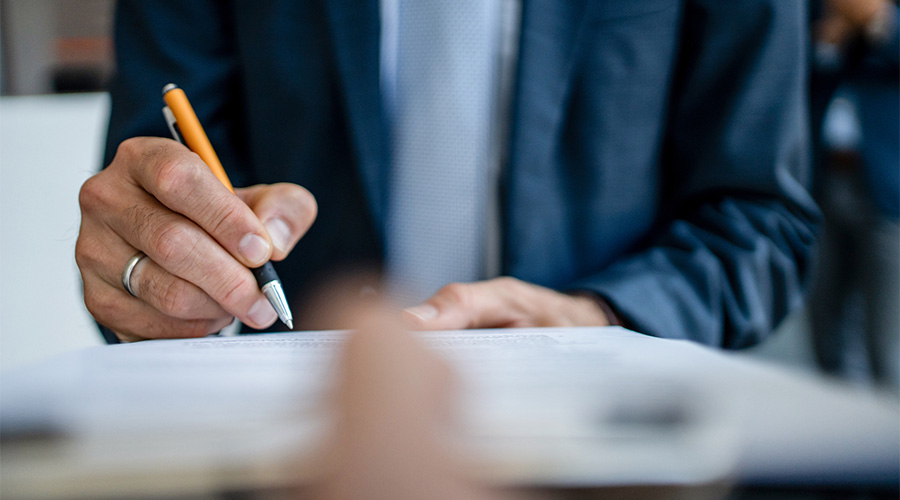 A pen marking a paper