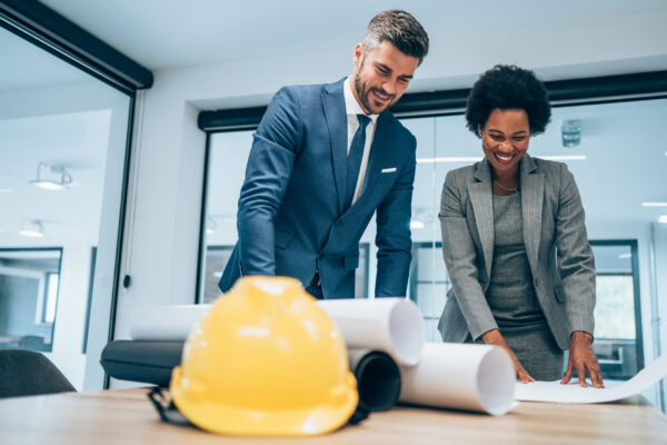 Two people checking a construction contract