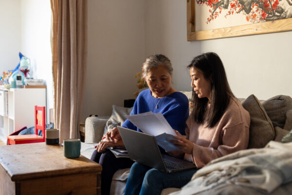 Two people sat checking a form
