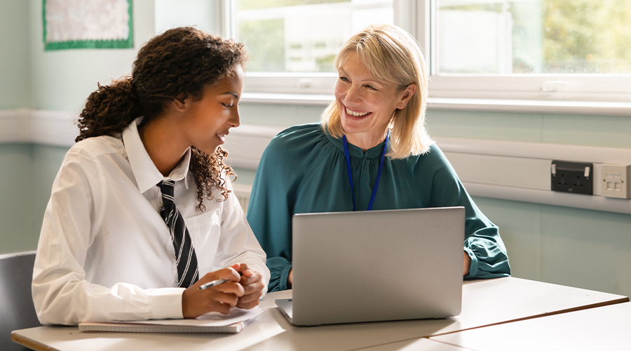 oung worker discussing employment terms with adviser during a consultation about zero‑hour contract rights, both seated at a desk with a laptop.