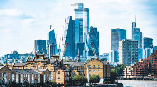 London skyline featuring modern City of London skyscrapers, including the Gherkin, overlooking riverside residential buildings, representing prime and super-prime property market.