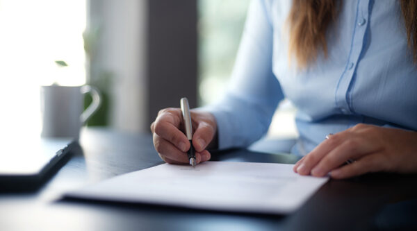 A businesswoman with a pen and document