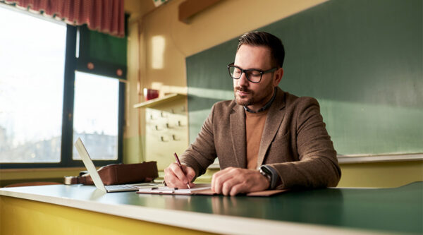 A teacher at a desk