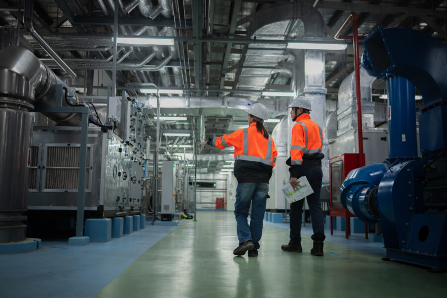 Two workers viewing technology infrastructure