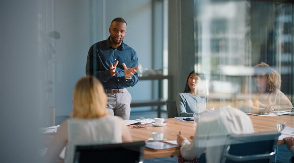 Business meeting discussing contract strategy, risk management and commercial planning before entering a third-party agreement.