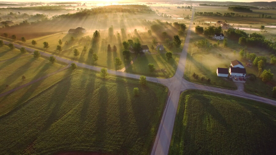 Magical sunrise through ground fog with long shadows and sunbeams.