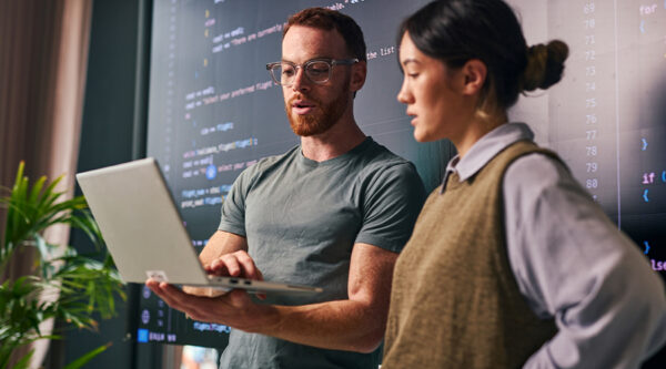 Man and Women looking at a laptop
