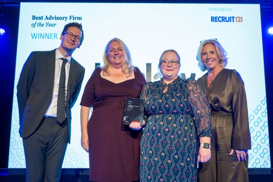 Four award recipients and presenters on stage celebrating a Best Advisory Firm of the Year win at an industry awards ceremony