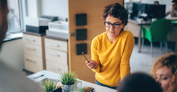 Woman in a meeting holding a pen