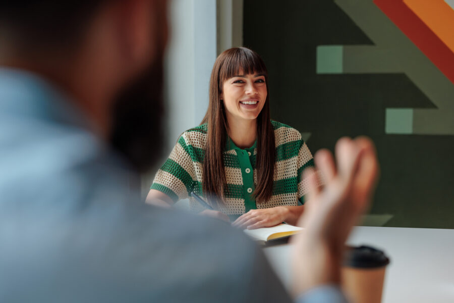 Business professionals discussing intellectual property matters during a meeting at a table.