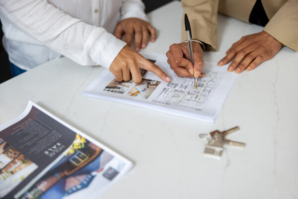 Two people looking at a plan